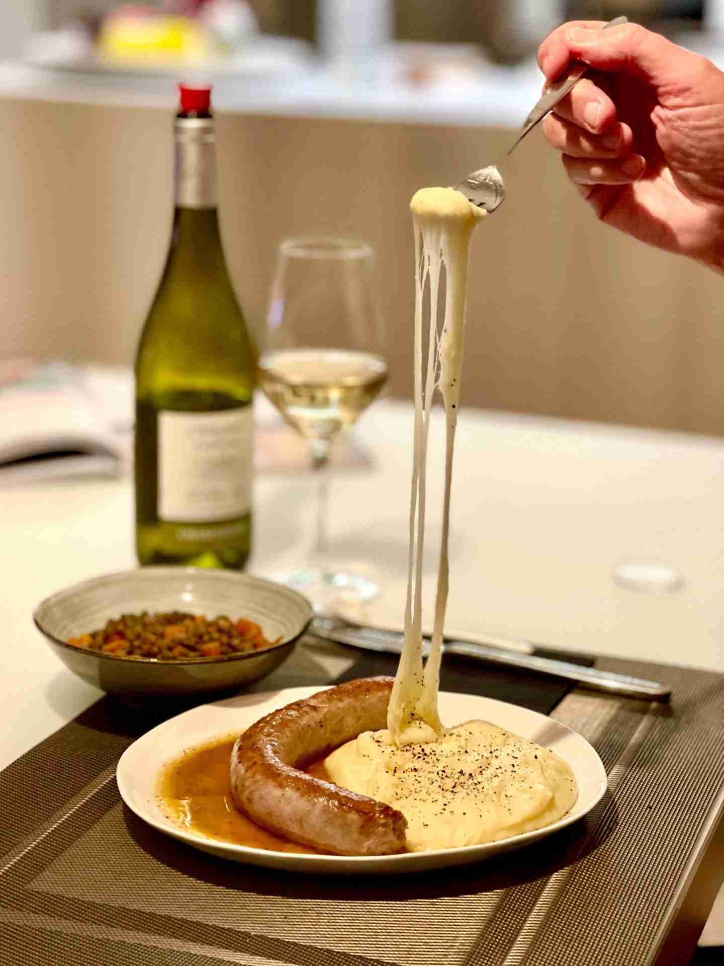 Learn how to make aligot, a traditional French dish made from mashed potatoes and cheese that has a stretchy and velvety texture.